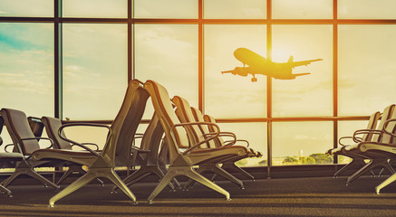 Fototapeta premium passenger seat in Departure lounge for see Airplane, view from airport terminal.sun light in vintage color selective focus,transport and travel concept...