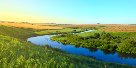 Sunny summer landscape.Green hills,fields and meadows.River Upa in Tula region,Russia.Sunrise.Quiet...