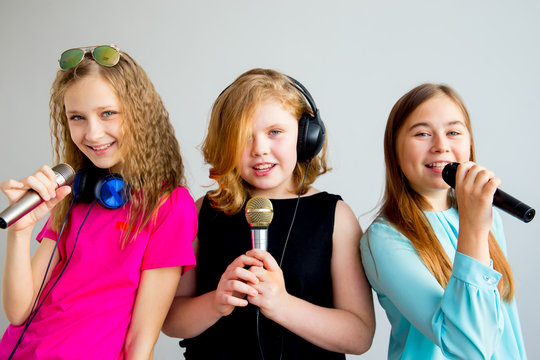 Girls singing in headphones
