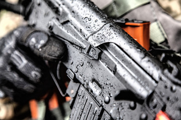 Close-up shot of Kalashnikov rifle automatic weapons in hands of army special forces soldier under...