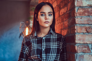 Portrait of an attractive brunette dressed in flannel shirt