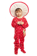 Little boy in a carnival costume of mushroom fly agaric on a white background