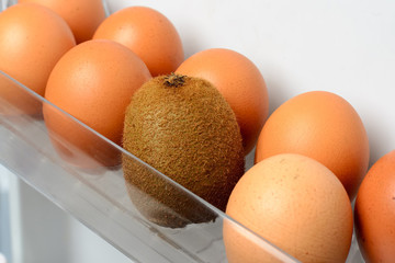 Tropical kiwi fruit surrounded by chicken eggs