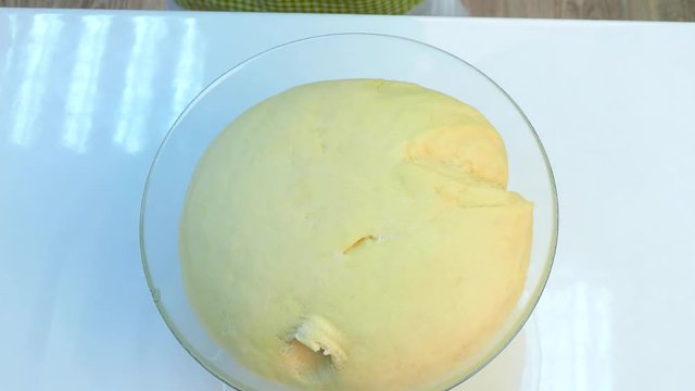 The chef puts the yeast dough on the table.