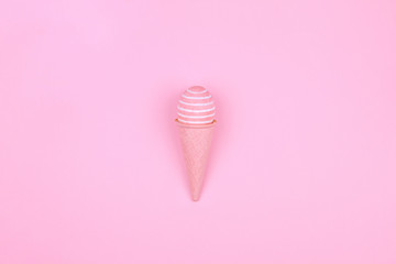 Happy Easter Day. Pink tradition easter egg with pink waffle cone on pink background