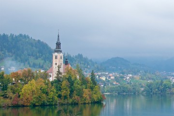 Fototapeta na wymiar Landscape surrounding ancient baroque church on Bled Island in Slovenia