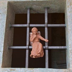 Small angel statue sitting on the window to remind people to keep quiet in church