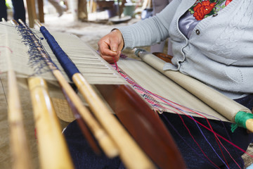 A woman is spinning with spinning machine