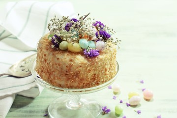 Homemade Coconut Cake With Easter Candies decoration, selective focus