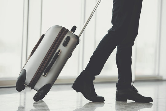Business Travel. Business people at airport. Airport hall with panoramic windows.