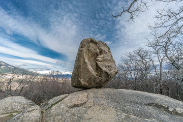 Celtic Vetton sacred place (Nemeton), Large boulder of granite rock surounded by trees at Silla de Felipe II (Phillip II chair) in Guadarrama Mountains near San Lorenzo del Escorial, Madrid, Spain