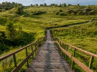 Long stair with vegetation and cloudy sky