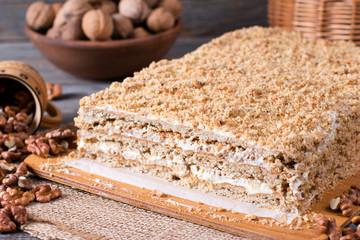 Homemade cake with nuts on a wooden board, homemade cake