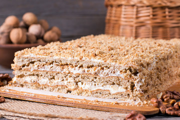 Homemade cake with nuts on a wooden board, homemade cake