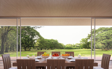 Modern contemporary dining room 3d rendering image.The Rooms have wooden lattice ceiling.furnished with wood furniture.There are large open doors. Overlooks wooden terrace and big garden.