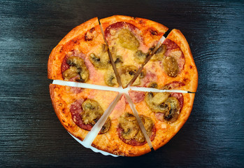 pizza on a dark wooden background