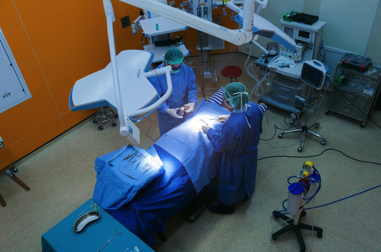 Top View Of Group Of Doctor And Assistant Surgeons Work For Rescue Patient In Operation Room At Hospital, Emergency Case, Surgery, Medical Technology, Health Care Cancer And Disease Treatment Concept