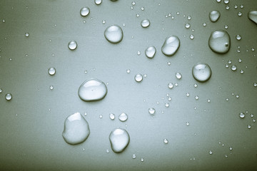 Drops of water on a color background. Gray. Toned
