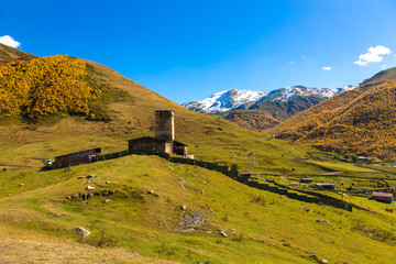 View of the village of Ushguli in a beautiful autumn landscape with white clouds in Svaneti. Georgia