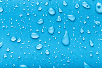 Drops of water on a color background. Blue. Toned