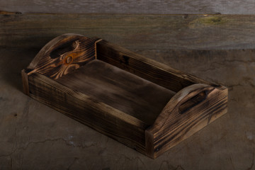 Handmade burned box on a wooden rustic texture for background. Rough weathered wooden board