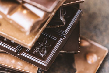 Chocolate bar pieces. Background with chocolate. Sweet food photo concept. The chunks of broken...