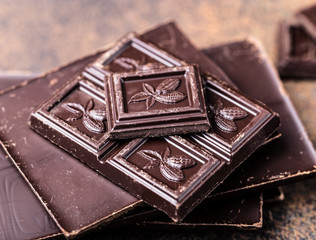 Chocolate bar pieces. Background with chocolate. Sweet food photo concept. The chunks of broken chocolate