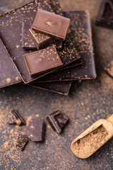 Chocolate bar pieces. Background with chocolate. Sweet food photo concept. The chunks of broken chocolate