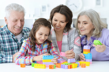 Fototapeta premium little cute girl with mother and grandparents playing together
