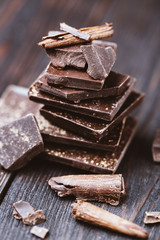 Chocolate bar pieces. Background with chocolate. Sweet food photo concept. The chunks of broken chocolate