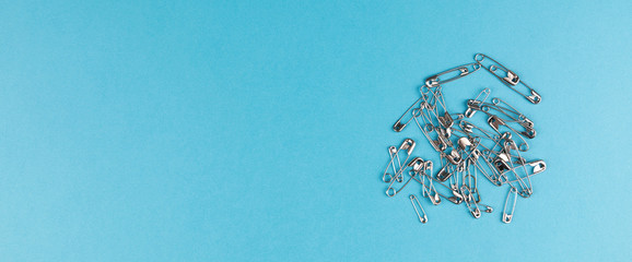 safety pins panorama blue background