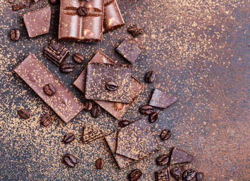 Chocolate bar pieces. Background with chocolate. Sweet food photo concept. The chunks of broken chocolate