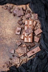 Chocolate bar pieces. Background with chocolate. Sweet food photo concept. The chunks of broken...