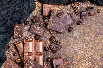 Chocolate bar pieces. Background with chocolate. Sweet food photo concept. The chunks of broken chocolate