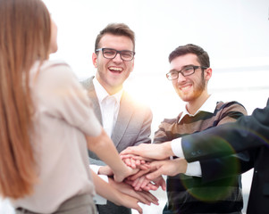 Business team standing joining hands together
