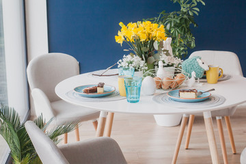 Pastel Easter table decoration on navy blue wall