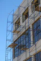 Scaffolding round building with sky at background