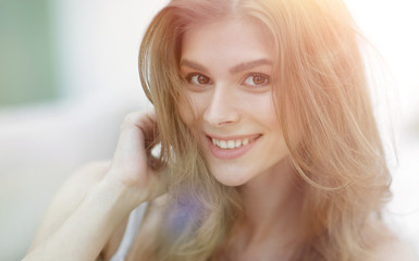 closeup portrait of a smiling young woman with light make-up