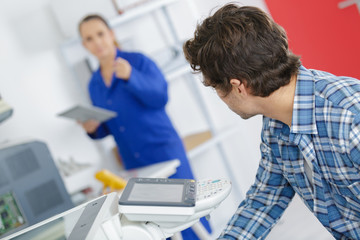 Obraz premium Man and woman in electrical workshop