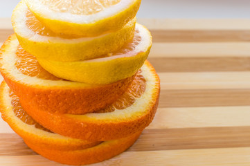 slices of a lemon and an orange a column. concept healthy food and vitamins