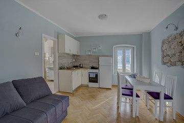 Interior of a living room with view from the window to the sea in a private house