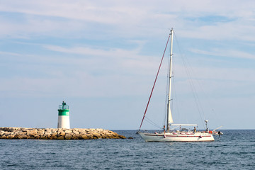 Sailboat being driven into harbor of Golfe Juan, Cote d'Azur