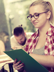 Student girl in front of her mates in classroom