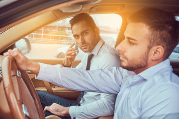 A handsome businessman in luxury car