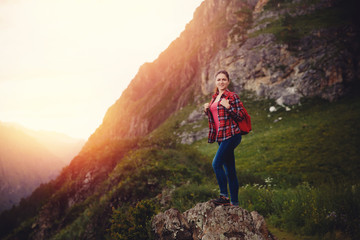 Fototapeta premium Traveling woman with backpack looking river and mountains, sunny day
