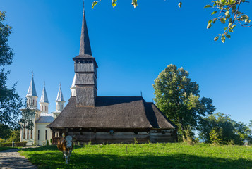 Fototapeta na wymiar Wooden and new church in Remetea Chioarului, Romania