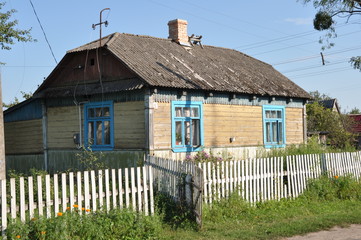 rural one-storey white house in the Ukrainian village in the summer