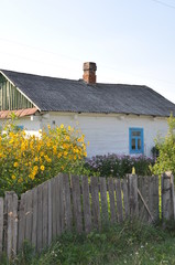 rural one-storey white house in the Ukrainian village in the summer