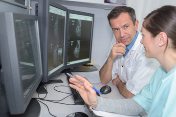 doctors checking mri machine screens