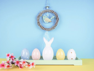 Creative easter composition with painted eggs and easter bunny.